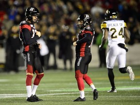 Ottawa Redblacks kicker Lewis Ward, right, (10) celebrates a field goal while taking on the Hamilton Tiger Cats during first half CFL action in Ottawa on Friday, Oct. 19, 2018. His field goal broke the record for consecutive field goals made.