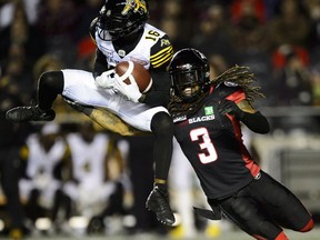 Tiger-Cats receiver Brandon Banks (16) makes a catch in front of Redblacks defensive back Rico Murray during Friday's game.