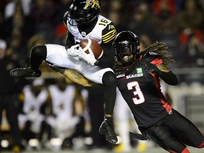 Hamilton Tiger-Cats wide receiver Brandon Banks (16) makes a catch as Ottawa Redblacks defensive back Rico Murray (3) tackles him during the second half in Ottawa on Friday, Oct. 19, 2018.