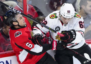 Senators defenceman Chris Wideman gets hit by the Chicago Blackhawks' Luke Johnson. (THE CANADIAN PRESS)