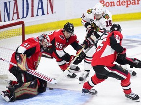 Defenceman Max Lajoie (58) helps Senator goalie Craig Anderson defensively in the season opener against the Blackhawks on Oct. 4. Now Lajoie is staying with Anderson at his home in Stittsville.