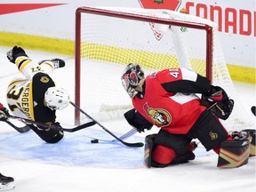 Senators goaltender Craig Anderson pulls the puck off the goal-line before Bruins forward Patrice Bergeron can knock it in during the first period.