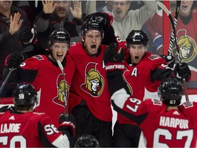Mark Stone, middle, has reason to rejoice after scoring the overtime-winning goal for the Senators against the Canadiens on Saturday night.