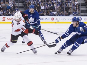 Senators defenceman Dylan DeMelo gets a shot away past the Maple Leafs' Travis Dermott during the first period of last Saturday's game in Toronto.