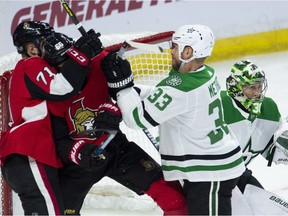 Stars defenceman Marc Methot clears Senators winger Magnus Paajarvi and centre Chris Tierney from the crease of netminder Ben Bishop during the first period of Monday's game at Canadian Tire Centre.