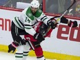 Dallas Stars left wing Jamie Benn battles with Ottawa Senators defenceman Chris Wideman behind the net during third period NHL action Monday October 15, 2018 in Ottawa.