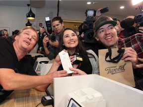 Canopy Growth CEO Bruce Linton, left to right, provides the receipt for the first legal cannabis for recreation use sold in Canada to Nikki Rose and Ian Power at the Tweed shop on Water Street in St. John's N.L. at 12:01 am NDT on Wednesday October 17, 2018.