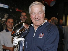 In this Sept. 28, 2009, file photo, Hall of Famer Jim Taylor, from the Green Bay Packers, walks the Vince Lombardi Trophy, through the Pro Football Hall of Fame after it was delivered by a Brinks armored car in Canton, Ohio.