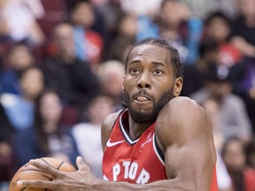 Newcomer Kawhi Leonard has been on the floor with Kyle Lowry throughout the Raptors training camp. (Jonathan Hayward/The Canadian Press)