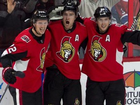 Senators right wing Mark Stone celebrates his game-winning goal with teammates Thomas Chabot (72) and Matt Duchene (95) against the Canadiens, in Ottawa on Saturday, Oct. 20, 2018.