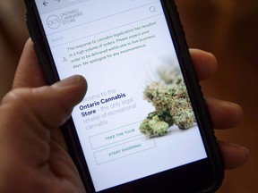 The Ontario Cannabis Store website is pictured on a mobile phone.