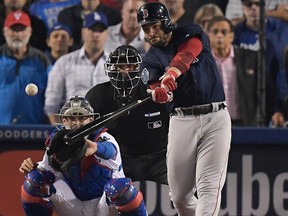 Boston Red Sox's Steve Pearce hits a three RBI-double against the Los Angeles Dodgers during the ninth inning in Game 4 of the World Series baseball game on Saturday, Oct. 27, 2018, in Los Angeles.