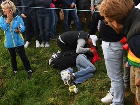 Corine Remande lies injured on the ground after being struck by a wayward shot the Ryder Cup. She has lost vision in her right eye and is planning on suing organizers.