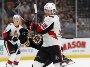 Senators forward Zack Smith (15) checks the Bruins' Ryan Donato during the second period of play on Monday.