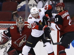 Ottawa Senators centre Jim O'Brien (40) tries to redirect the puck as Arizona Coyotes defenceman Oliver Ekman-Larsson (23) applies pressure and Antti Raanta, left, watches the puck Saturday, March 3, 2018, in Glendale, Ariz. (AP Photo/Ross D. Franklin)