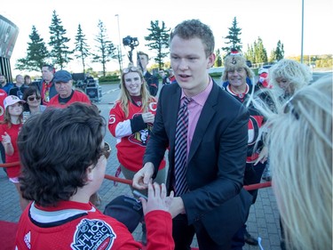 Brady Tkachuk greets hockey fans lined up along the red carpet.