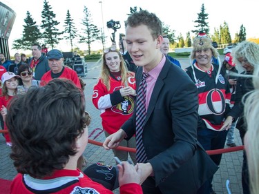 Brady Tkachuk greets hockey fans lined up along the red carpet.