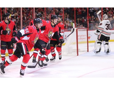 Colin White, left, and Max Lajoie skate back to the bench after White scored on goalie Cam Ward in the first period.