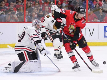 Alex Formenton tries to control the puck in front of goalie Cam Ward.