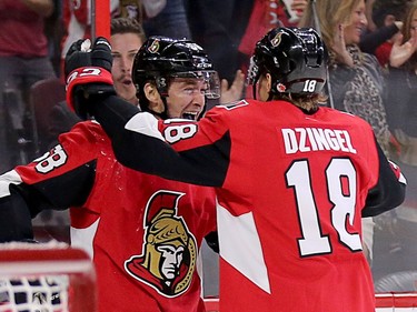 Defenceman Max Lajoie, left, celebrates with Ryan Dzingel after scoring his first NHL goal in the first period of his first NHL regular-season game.