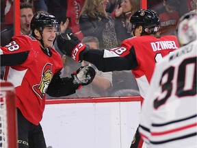Max Lajoie (L) celebrates his first ever NHL goal with Ryan Dzingel in the first period as the Ottawa Senators take on the Chicago Black Hawks in their season opener of NHL action at the Canadian Tire Centre.