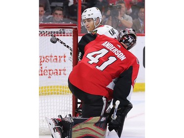 Craig Anderson looks over at Patrick Kane, who watches as his shot finds the net in overtime.