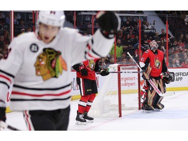 Goalie Craig Anderson looks over at Patrick Kane as he celebrates his goal in overtime.