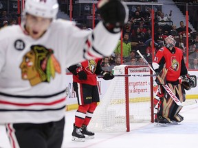 Craig Anderson (R) looks over at Patrick Kane (L) as he celebrates his goal in the overtime period as the Ottawa Senators take on the Chicago Blackhawks in their season opener of NHL action at the Canadian Tire Centre.