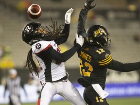 The Redblacks’ Sherrod Baltimore makes life difficult for Tiger-Cats wide receiver Mike Jones on Saturday in Hamilton.
