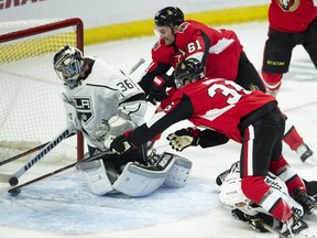 Senators forwards Mark Stone and Colin White dive to push the puck across the goal line as Los Angeles Kings goalie Jack Campbell reaches behind him on Saturday at Canadian Tire Centre. (Adrian Wyld/The Canadian Press)