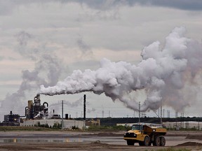 A dump truck works near the Syncrude oil sands extraction facility near the city of Fort McMurray, Alta., on June 1, 2014.