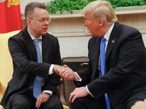 Freed American pastor Andrew Brunson (left) shakes hands with U.S. President Donald Trump at the White House in Washington, D.C., Saturday, Oct. 13, 2018.