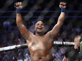 In this July 7, 2018, file photo, Daniel Cormier celebrates after defeating Stipe Miocic in a heavyweight title mixed martial arts bout at UFC 226 in Las Vegas. Cormier will defend the title against Derrick Lewis in the main event of UFC 230 on Nov. 3 against Madison Square Garden in New York.