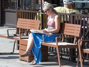 A woman enjoys a good read in the Byward Market as a warm and sunny fall afternoon made for a pleasant day for many who made sure to take advantage of it.