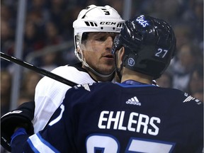 Los Angeles Kings defenceman Dion Phaneuf has a discussion with Winnipeg Jets forward Nikolaj Ehlers.