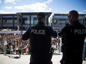 Two police officers survey the scene at Lansdowne during the 2017 Heineken Escapade 2017 electronic music festival.   Ashley Fraser/Postmedia