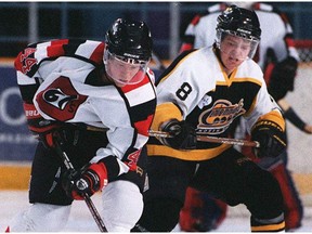 Chris Neil, seen battling against the Ottawa 67's Brian Campbell in 1998, had 65 goals, 91 assists and 596 penalty minutes during his career with the North Bay Centennials from 1996-99.
