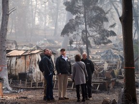 Gov.-elect Gavin Newson, FEMA Director Brock Long, President Donald Trump, Paradise mayor Jody Jones and Gov. Jerry Brown tour the Skyway Villa Mobile Home and RV Park during Trump's visit of the Camp Fire in Paradise, Calif., on Saturday.