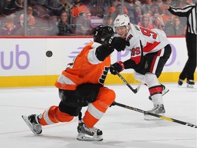 Senators centre Matt Duchene, right, follows through after batting the puck out of mid-air past Flyers defenceman Radko Gudas. The puck also eluded netminder Anthony Stolarz for what became the winning goal on Tuesday night.