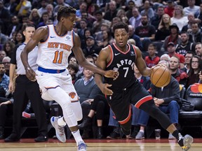 Toronto Raptors guard Kyle Lowry dribbles against New York Knicks guard Frank Ntilikina during Saturday's game. (THE CANADIAN PRESS)