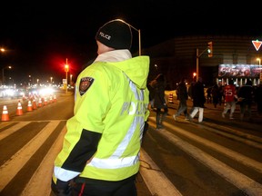 Off-duty police officers direct traffic outside Canadian Tire Centre on Ottawa Senators' game night.