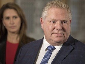 Ontario Attorney General Caroline Mulroney, left, looks on as Ontario Premier Doug Ford speaks to media following his meeting with Quebec Premier Francois Legault , not shown, at Queens Park, in Toronto on Nov. 19, 2018. (The Canadian Press)