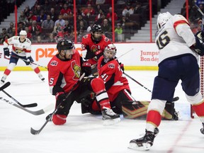 Florida Panthers centre Aleksander Barkov (right) blasts the puck past Ottawa Senators goaltender Craig Anderson as defenceman Cody Ceci and Zack Smith  on Monday night. (THE CANADIAN PRESS)