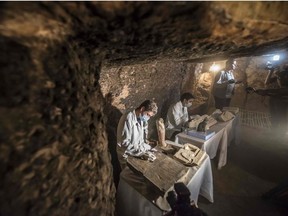 Egyptian archaeologist work on monuments during a new discovery made by an Egyptian archaeological mission during excavation work at the area located on the stony edge of King Userkaf pyramid complex in Saqqara Necropolis south of the capital Cairo on November 10, 2018.