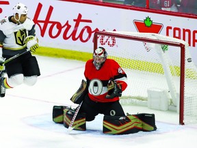 The puck gets past Ottawa Senators goaltender Craig Anderson (41) as he is screened by Vegas Golden Knights right wing Ryan Reaves (75) on a shot by Vegas Golden Knights defenceman Shea Theodore, not shown, during first period NHL hockey action in Ottawa on Thursday, November 8, 2018. THE CANADIAN PRESS/Fred Chartrand