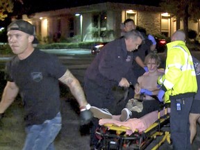 In this image taken from video a victim is treated near the scene of a shooting, Wednesday evening, Nov. 7, 2018, in Thousand Oaks, Calif.