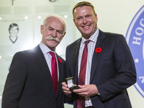 Hockey Hall of Fame chairman Lanny McDonald presentsMartin Brodeur with his ring on Friday. ERNEST DOROSZUK/TORONTO SUN