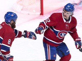 Canadiens' Jonathan Drouin, right, celebrates his goal against the Sabres with teammate Jordie Benn during first period NHL action in Montreal on Nov. 8, 2018.