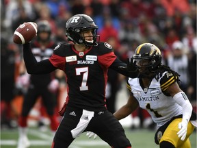 Ottawa Redblacks Trevor Harris (7) throws the ball as Hamilton Tiger-Cats Don Unamba (1) defends, during first half CFL East Division final football action in Ottawa on Sunday, Nov. 18, 2018.