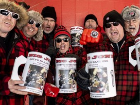 Ottawa Redblacks fans Colin Hamilton, Claudio Filice, Dave Winton, Kevin Meade, Steve Downer, Rod Emby and Ron Emby hold their pitchers in tribute to Redblacks offensive lineman Jon Gott.